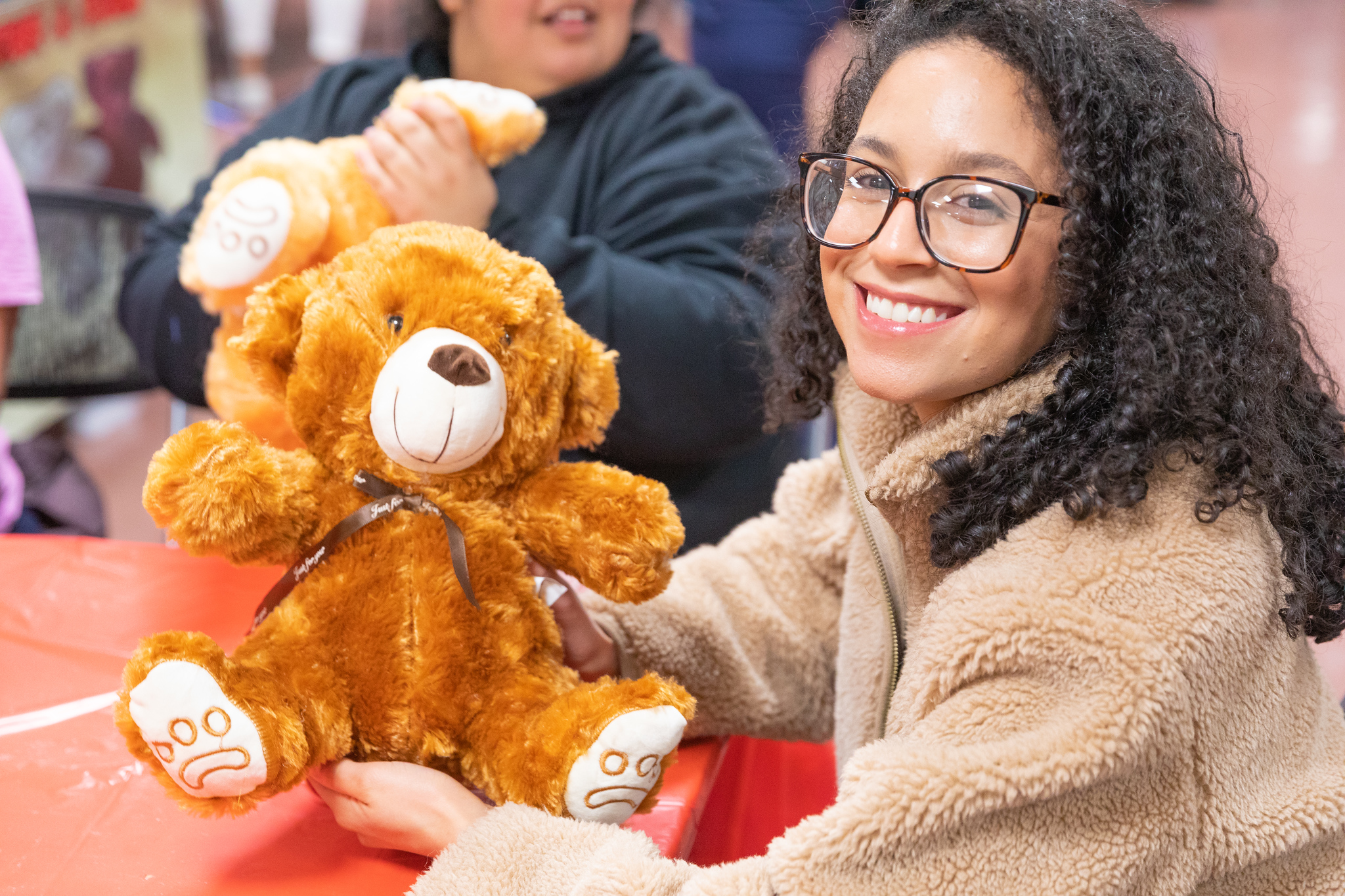 Student holding teddy bear