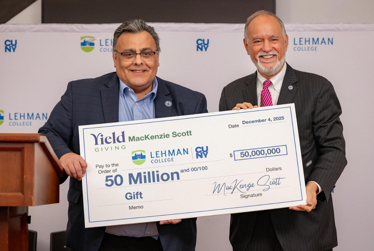 President of Lehman with chancellor of cuny holding big check