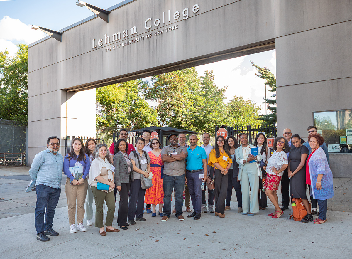 A wide shot of group of new faculty members standing together outside Lehman College