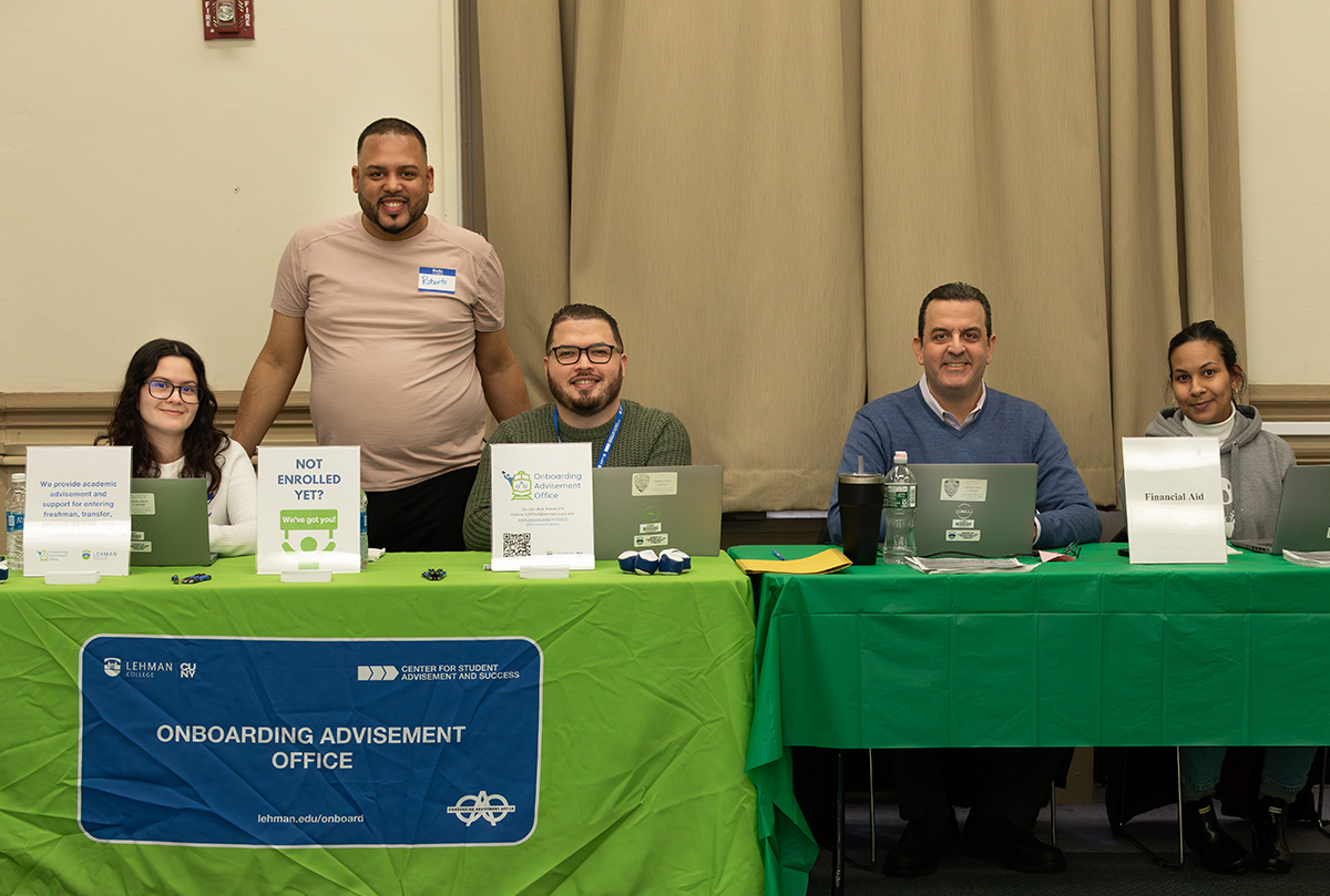 Photo of Onboarding Advisement and Financial Aid Staff sitting by a table