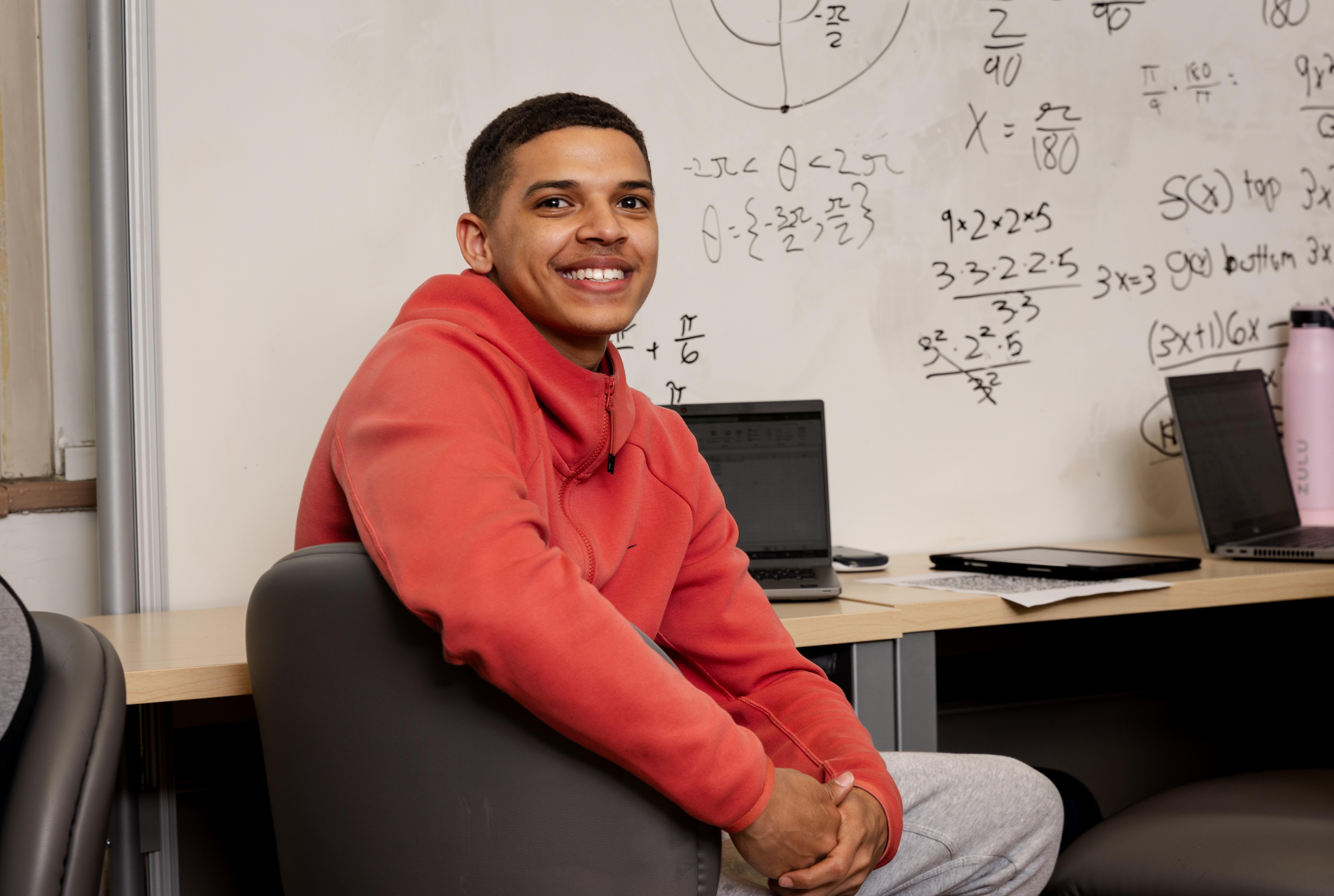 student smiling with on a math workshop