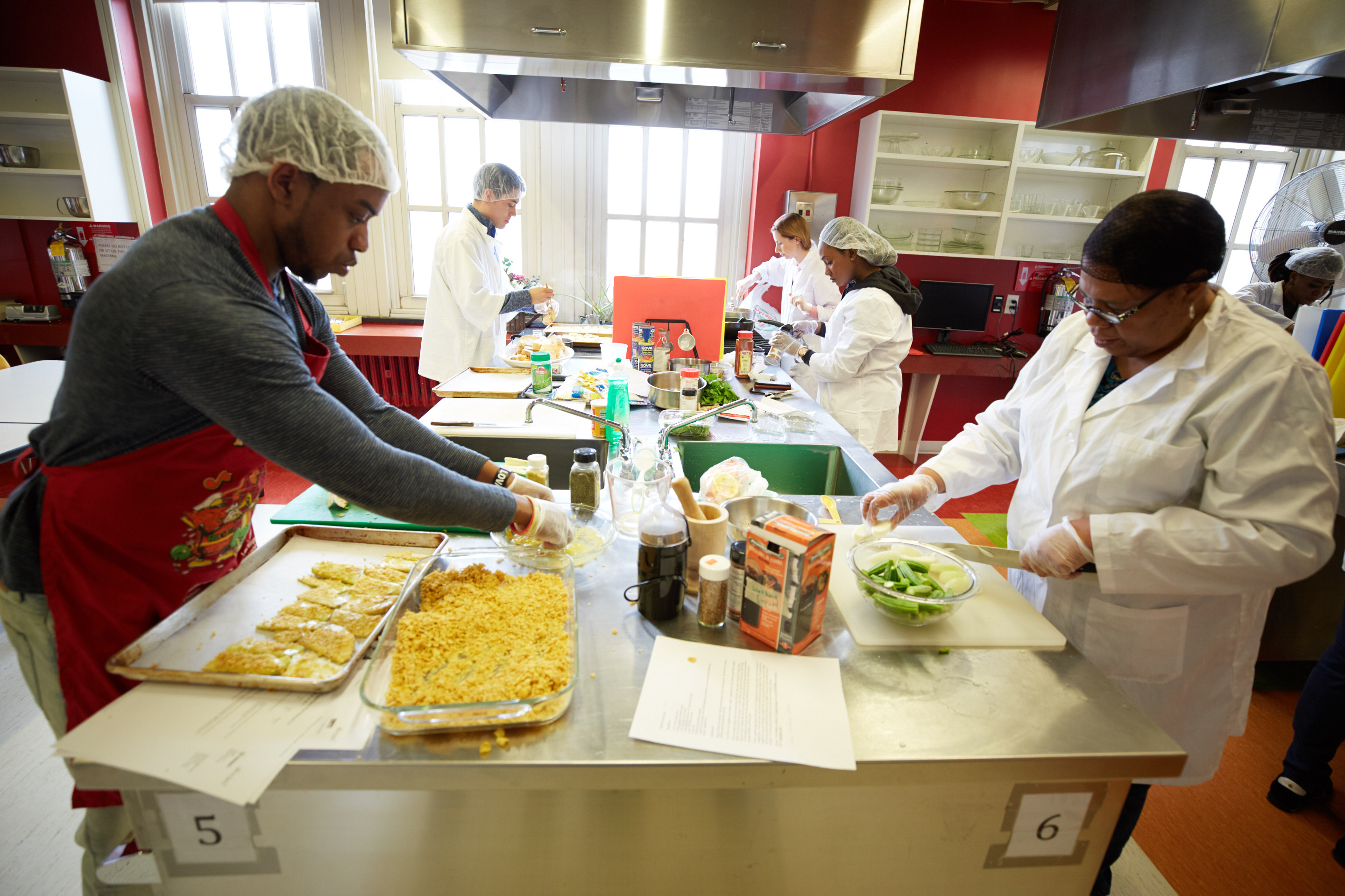 Students prepare food in Lehman's cooking lab.