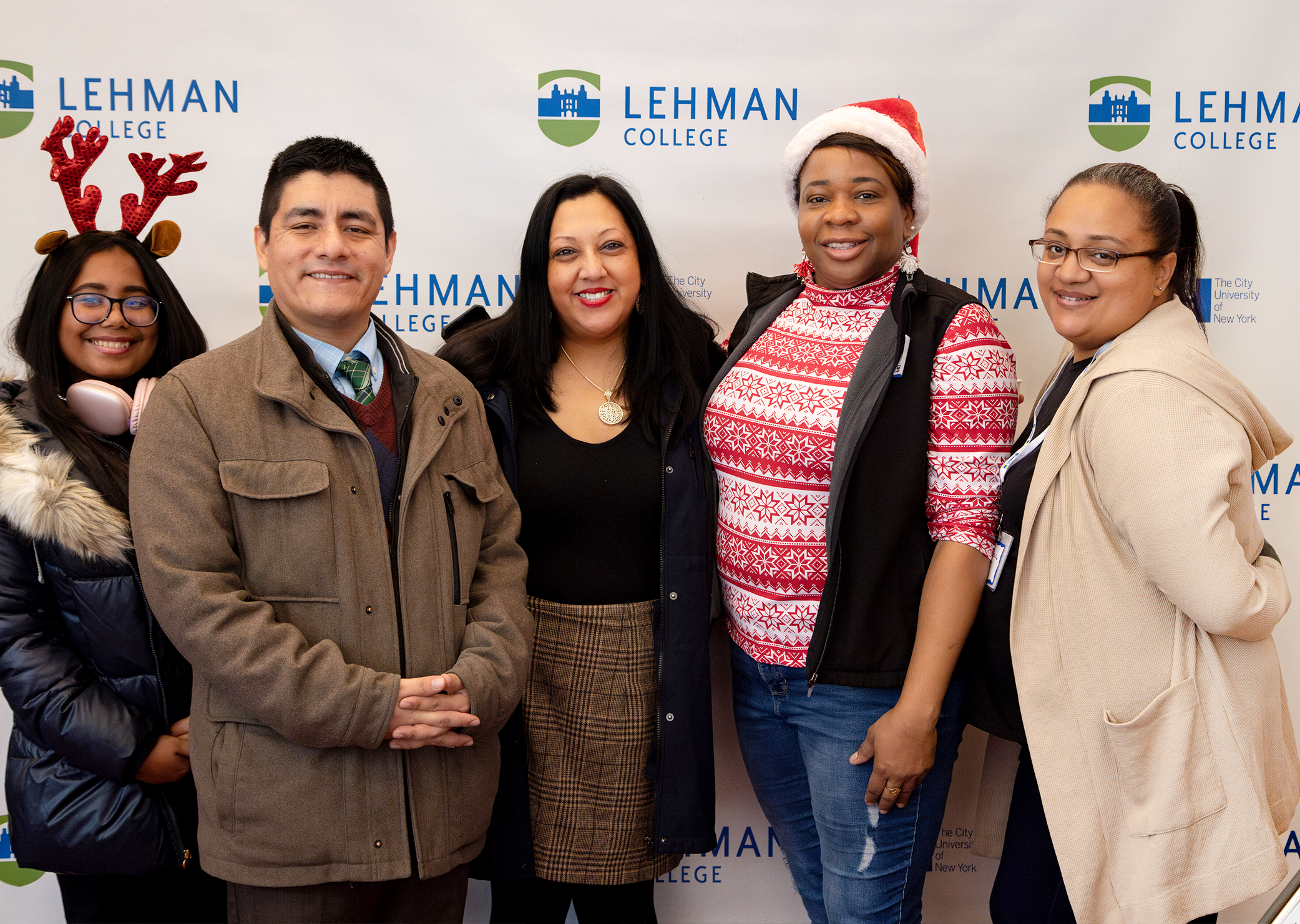 Photo of the Week: Leaders of Lehman's Empower-U Club including Lehman Weekly photographer Mildred Perez (at right) pose with Office of Campus Life advisors at the Provost's Holiday Fest.  
