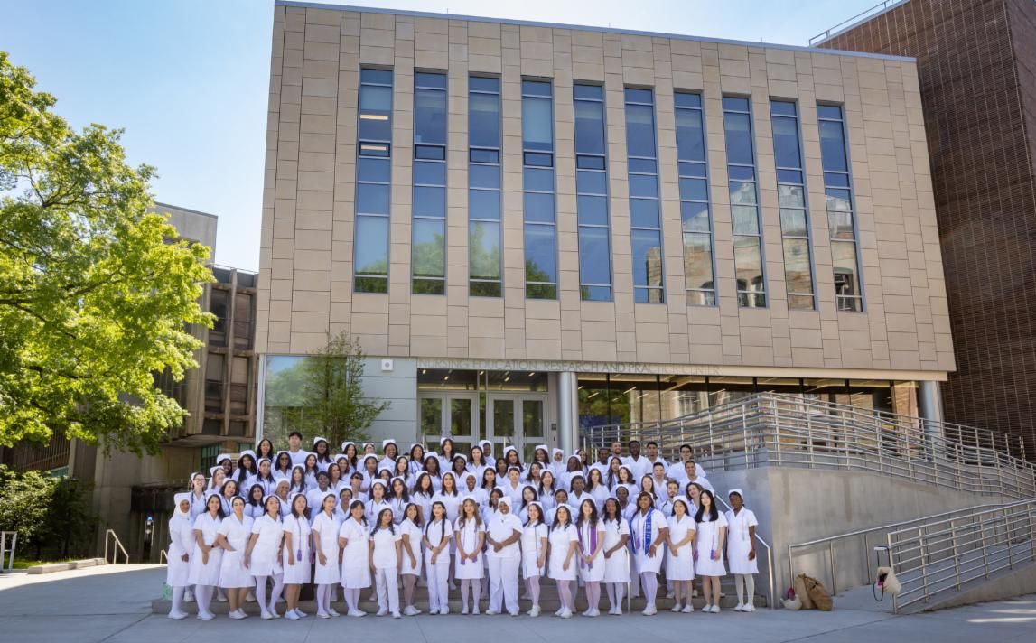 Lehman nursing students pose in front of the Nursing Education, Research, and Practice Center, a few months after the building first opened in February. (Photo by Lehman College Multimedia Center)