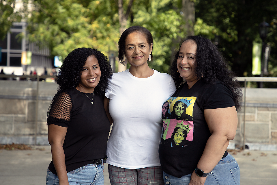 Michelle Velez, Evette Rodriguez, and Gloria Ramos posing together on campus.