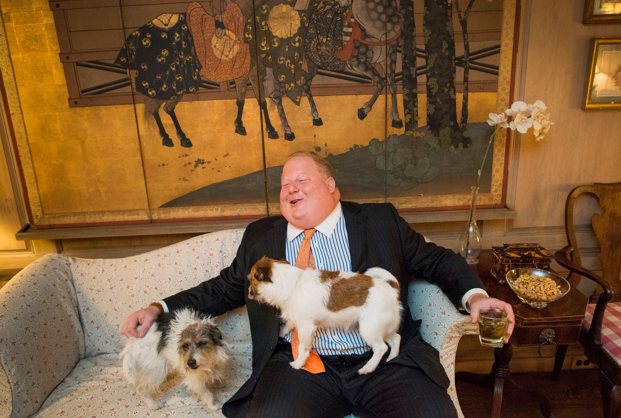 William Lash sitting on a sofa with his dogs.