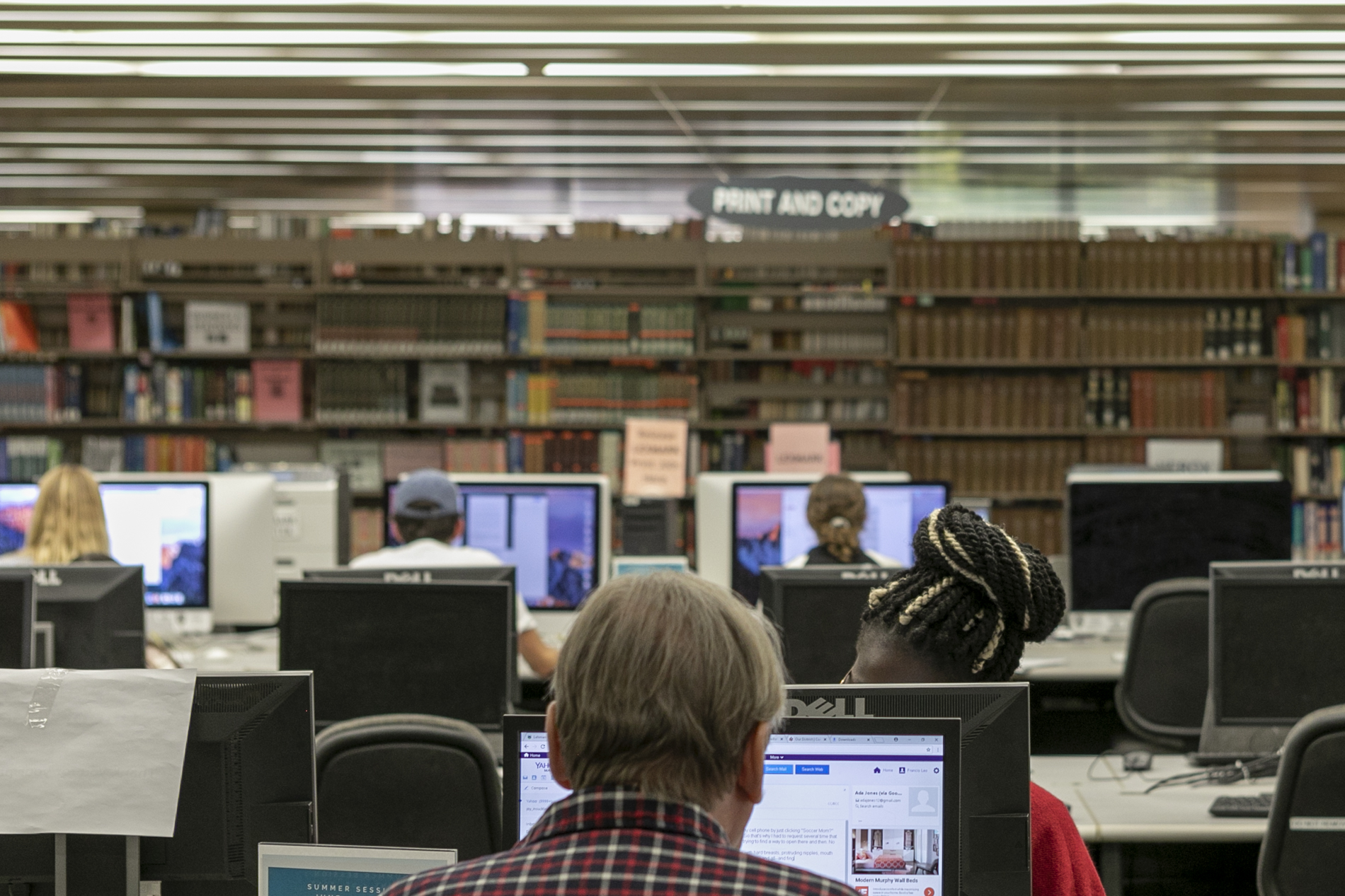 Students using the library's computer work stations.