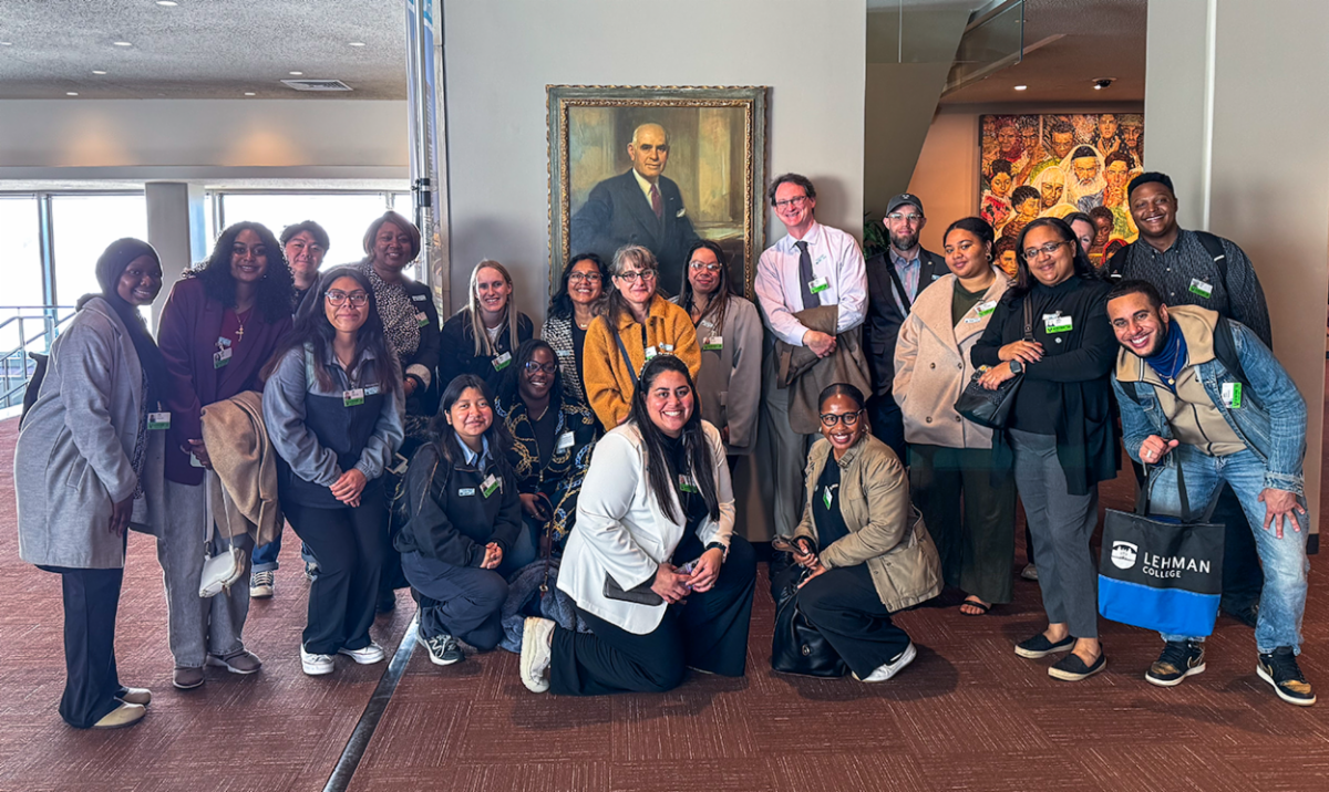 Members of the Lehman community pose with a portrait of Herbert H. Lehman, the College's namesake, during a visit to the United Nations.  