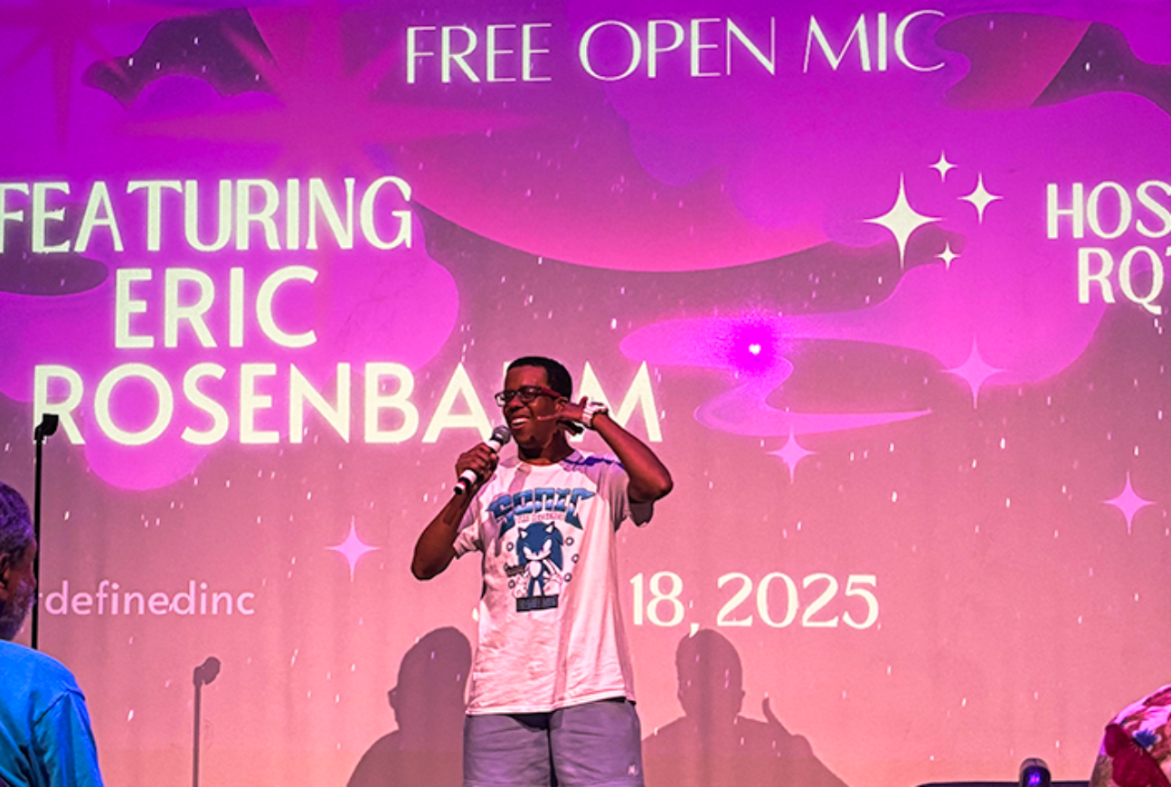 A Lehman student takes the stage in the Lovinger Theatre during an open mic event featuring Eric Rosenbaum and hosted by R.Q. TEK and Art Defined. (Photo by Mildred Perez)