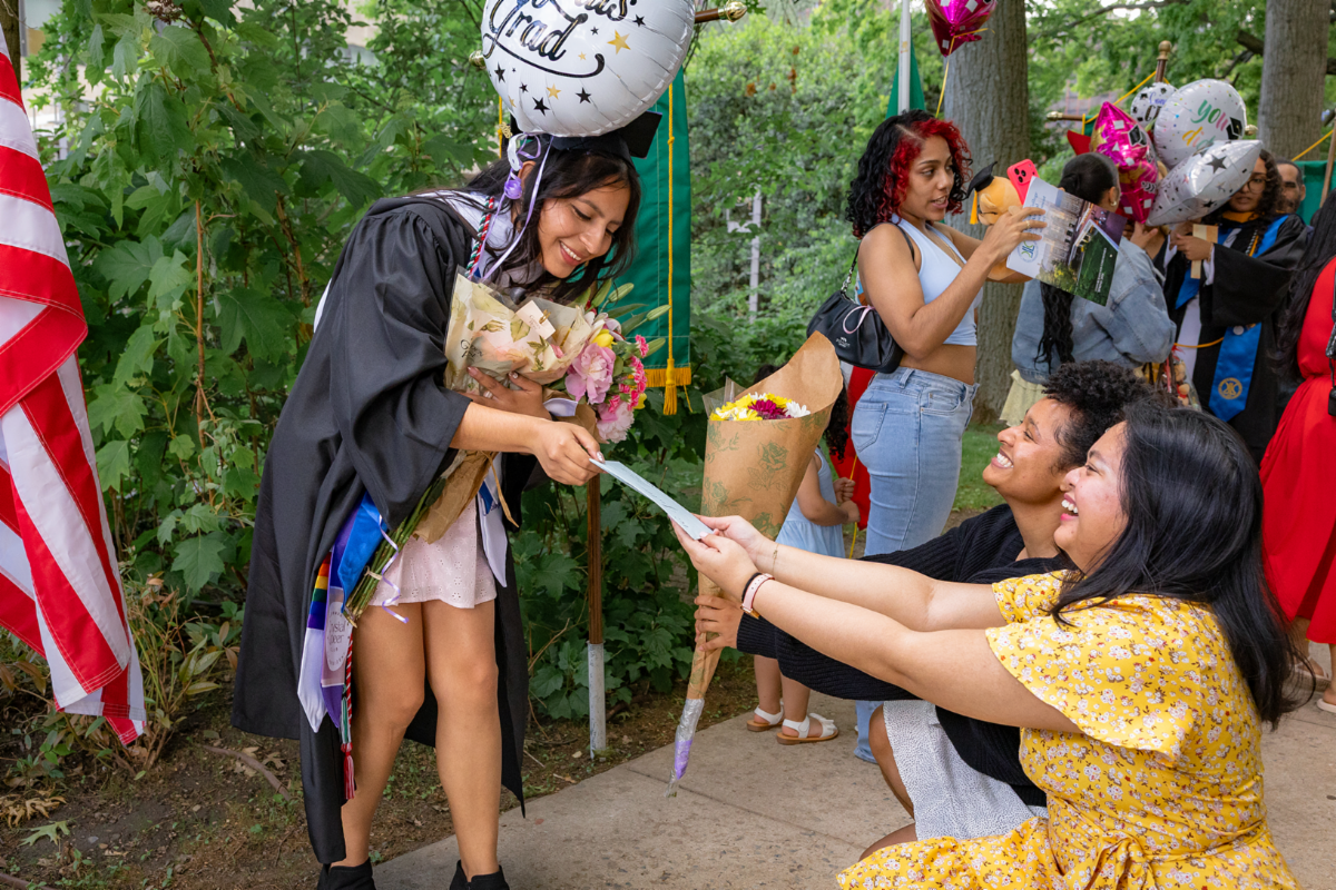 Graduate Julia Islas received more than her diploma at commencement, as friends showered her with flowers and gifts after the ceremony