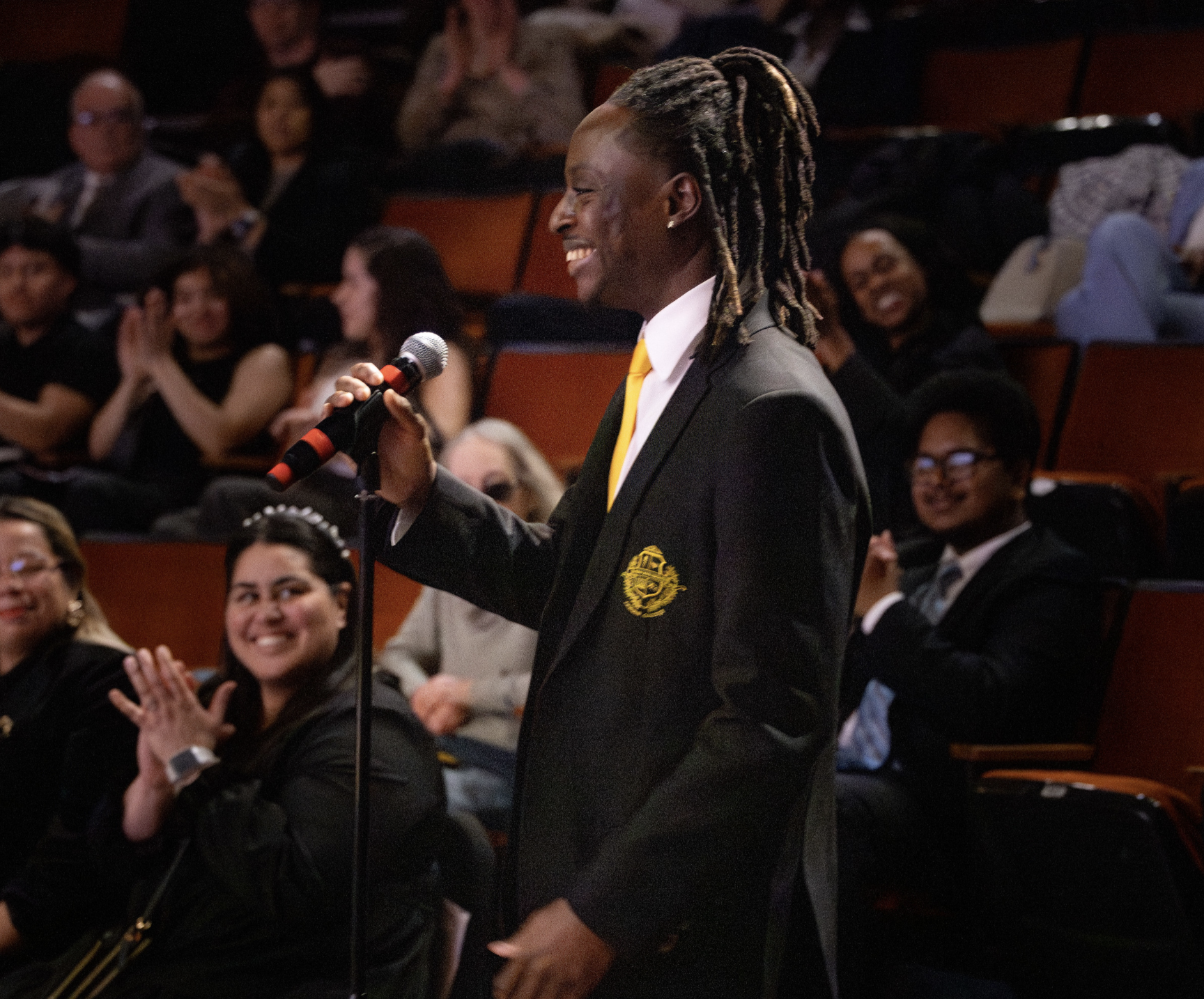 A student in an auditorium asks a question.