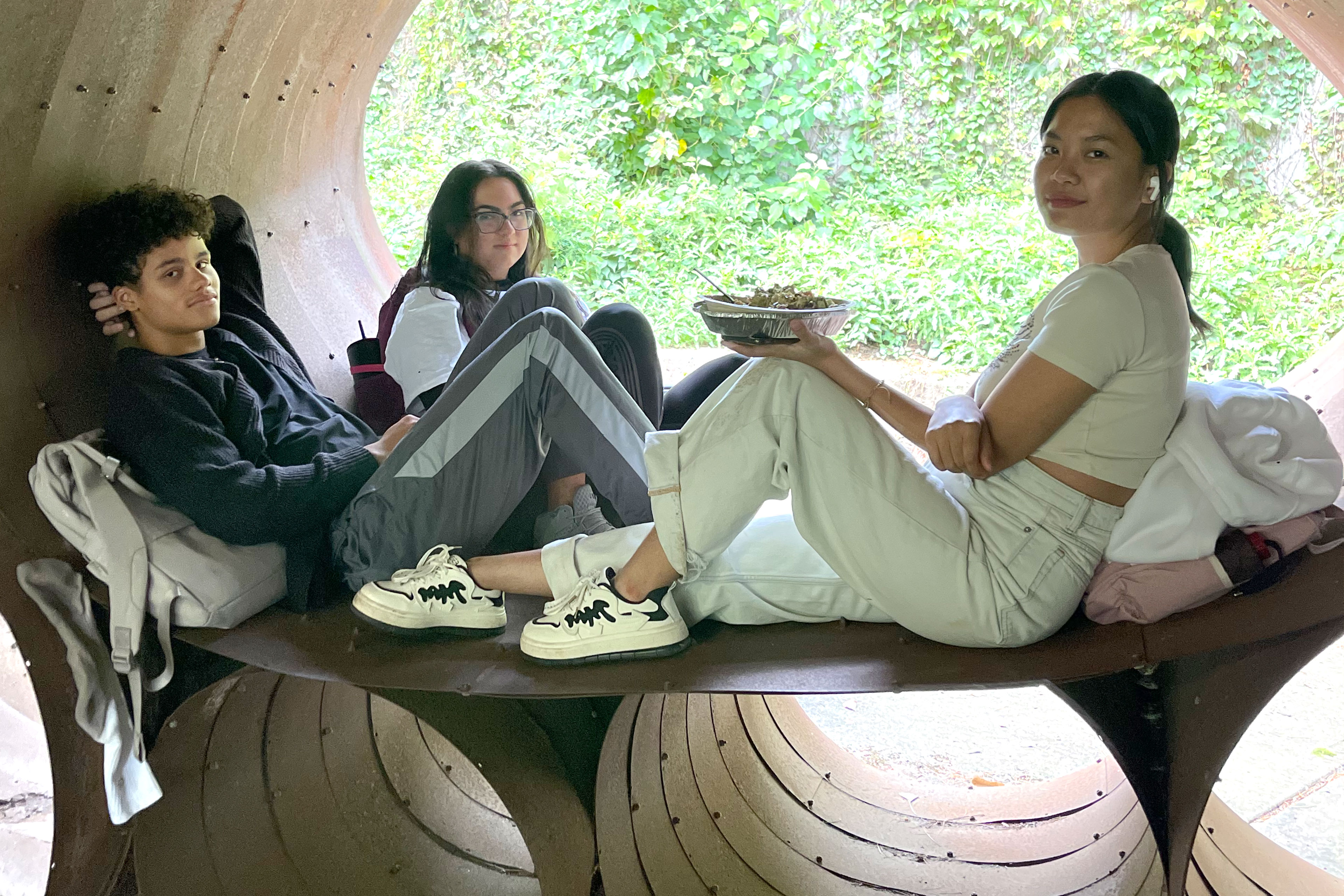 At last week's Club Fair, some students hung out near the quad, in Lehman's concave steel sculpture by DeWitt Godfrey. (Photo by Mildred Perez)