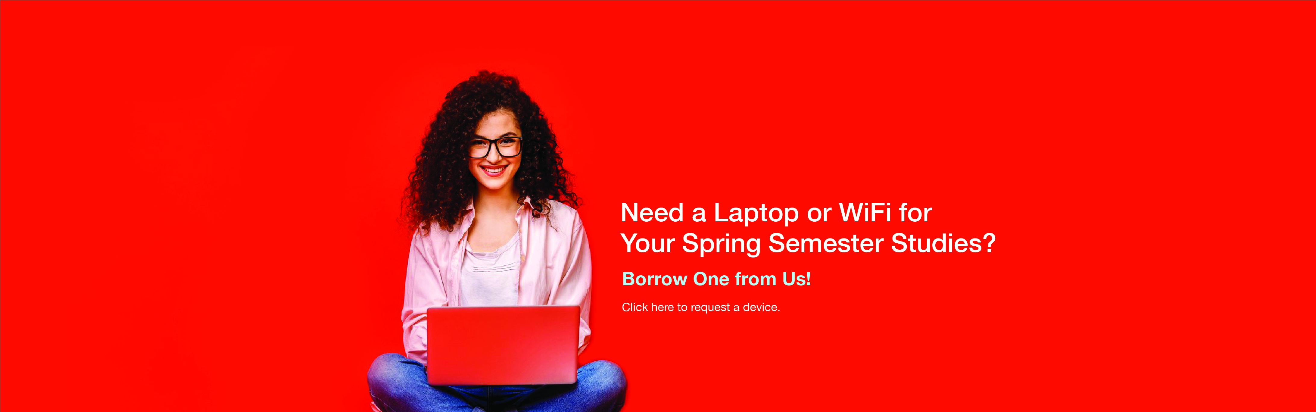 A young woman with brown hair sits crosslegged with an open laptop in her lap against a red background
