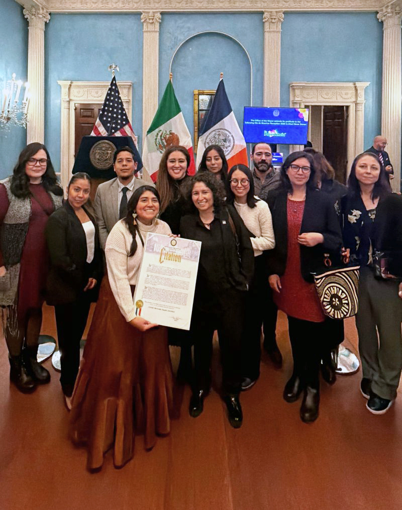 Students and staff of the CUNY Mexican Studies Institute at Lehman pose with a citation at Gracie Mansion.