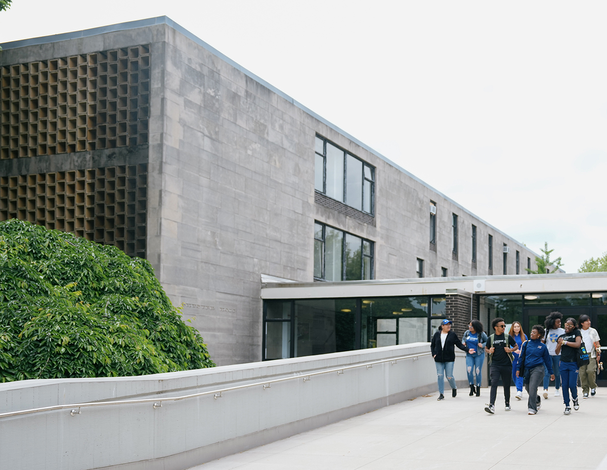 Photo of Shuster Building with students walking by