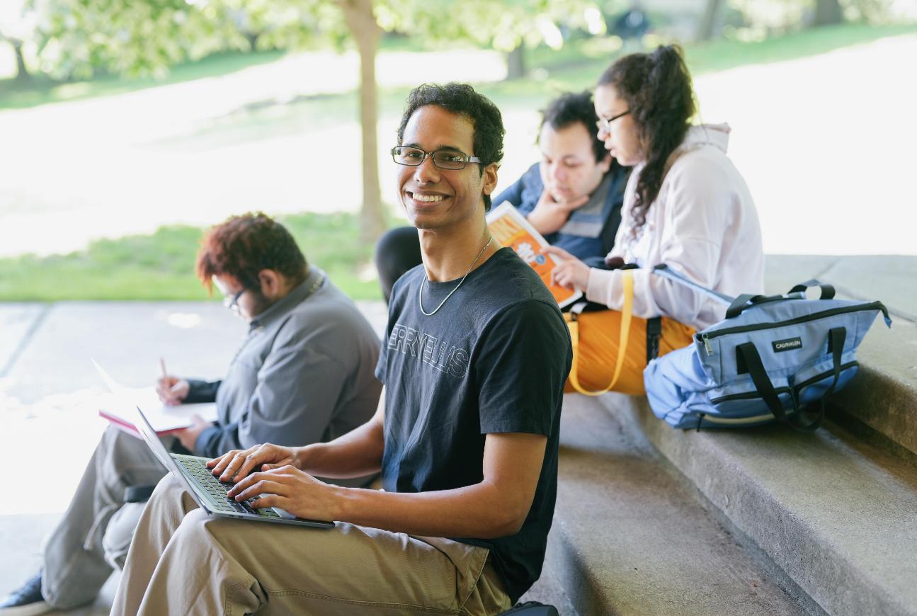 Lehman Students sitting outside on campus