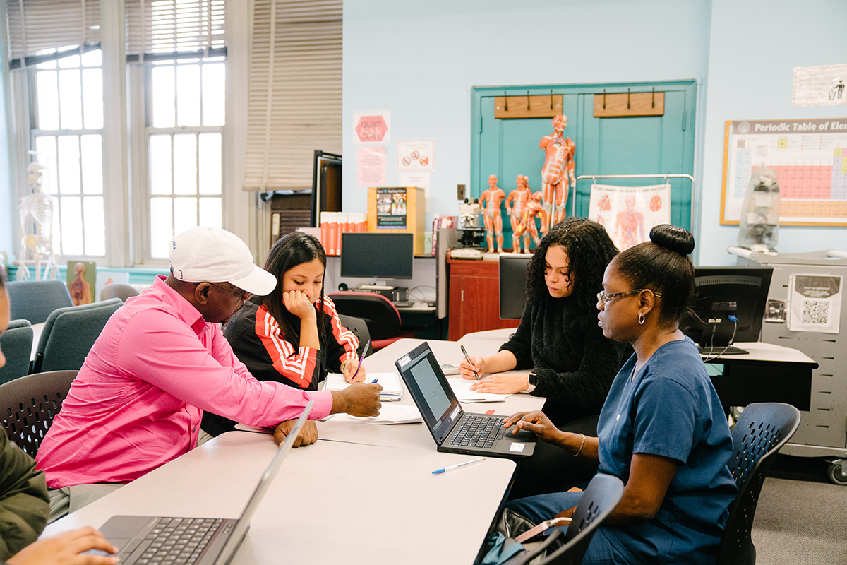 Photo of students and tutor at Tutoring Center